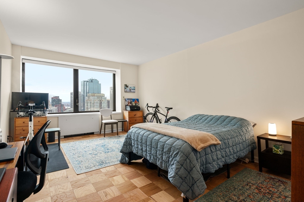 85 East India Row, Unit 36G Boston, MA 02110 - Photo 20 of 29 a bedroom with a bed and a two couches