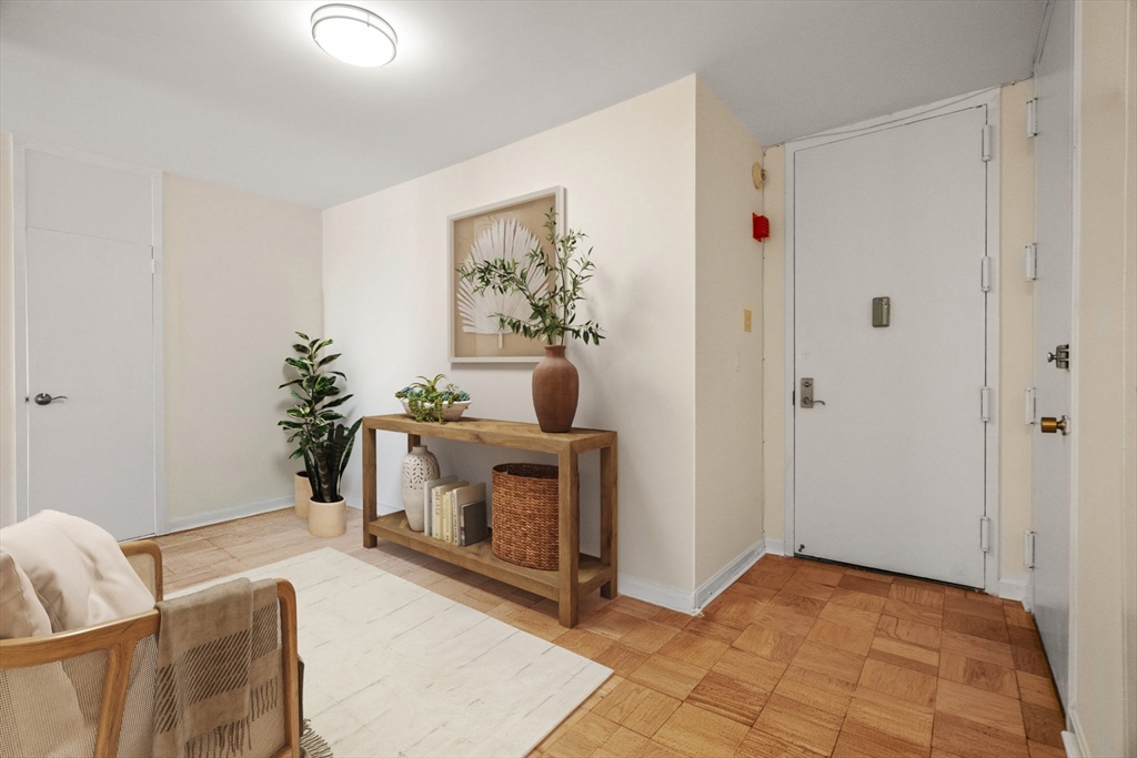 85 East India Row, Unit 36G Boston, MA 02110 - Photo 2 of 29 a living room with furniture and a potted plant