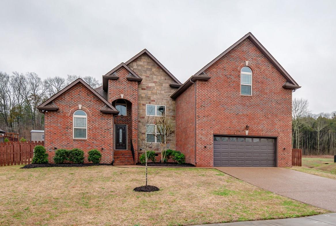 a front view of a house with a yard and garage