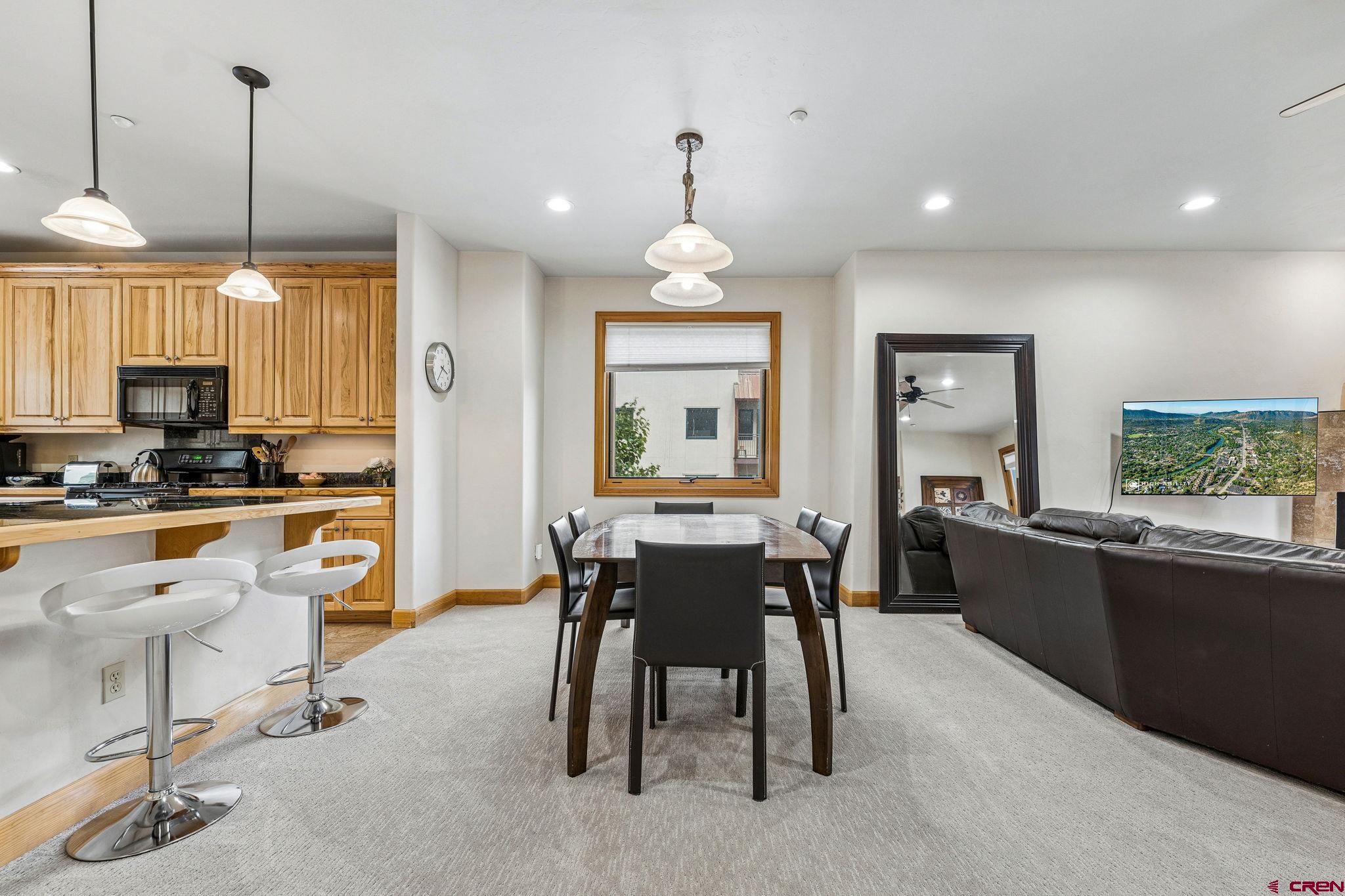 1422 Animas View Drive, Unit 55 Durango, CO 81301 - Photo 13 of 44 a dining table chairs and a view of kitchen