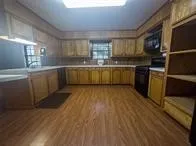 a kitchen with sink cabinets and wooden floor