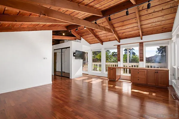 a view of outdoor space with wooden floor and windows