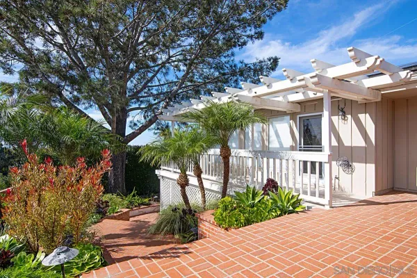 a view of a house with swimming pool and sitting area