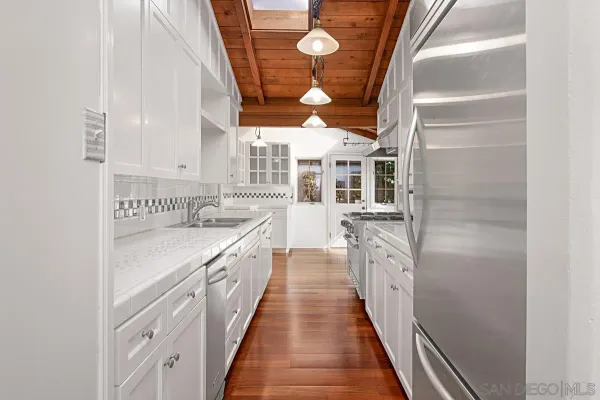 a kitchen with cabinets and window