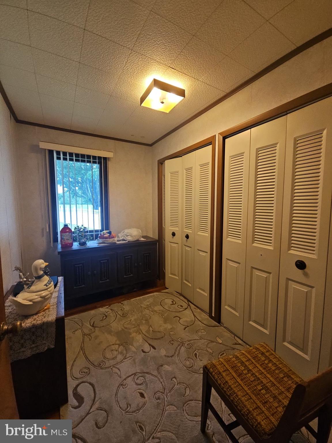 282 Woodruff Road Bridgeton, NJ 08302 - Photo 11 of 19 a bedroom with a bed and a dresser next to a window