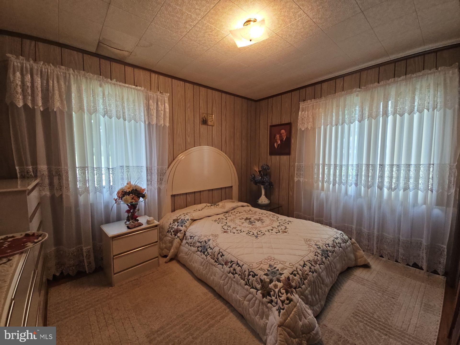 282 Woodruff Road Bridgeton, NJ 08302 - Photo 12 of 19 a bedroom with a bed and large windows