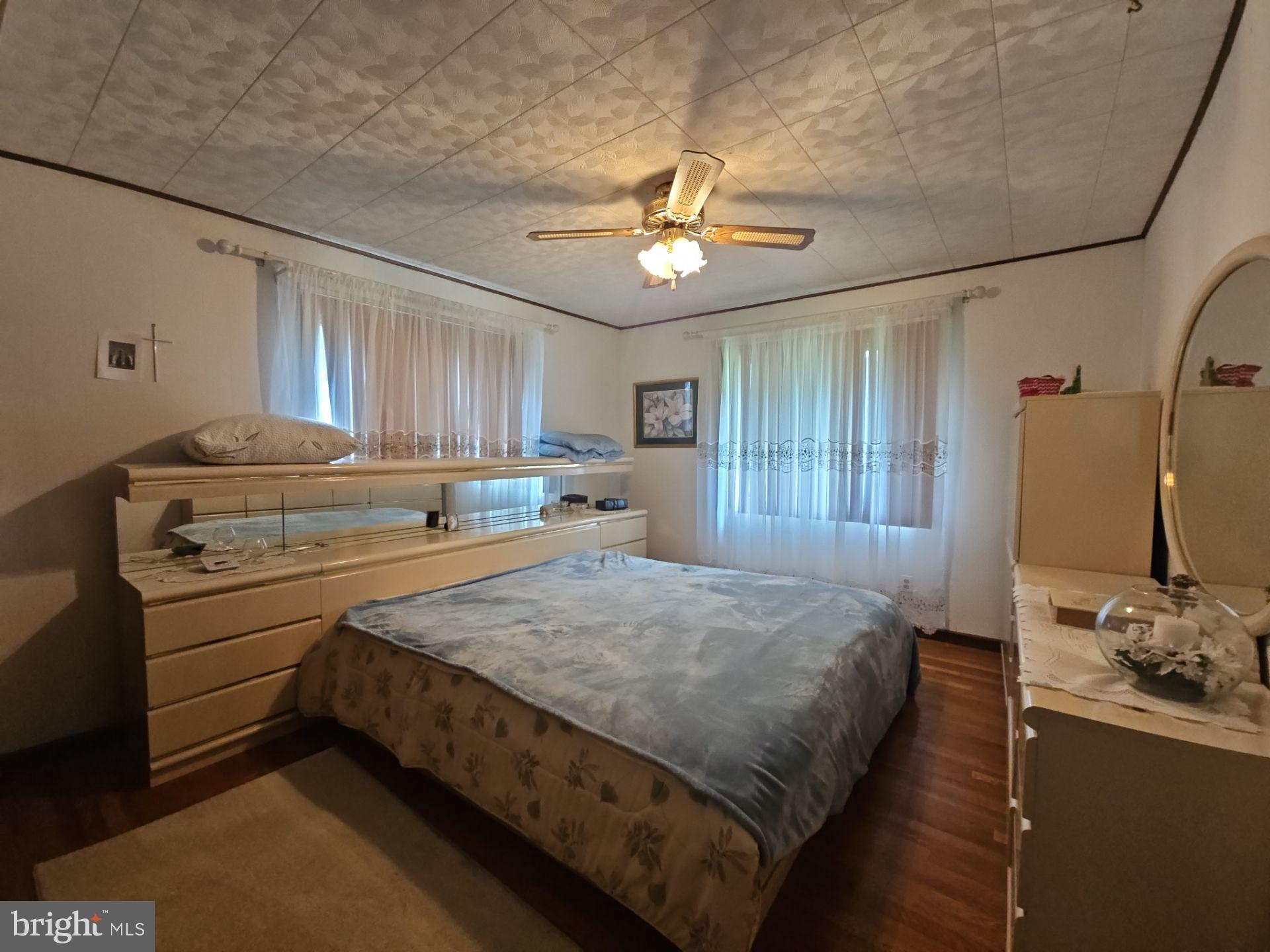 282 Woodruff Road Bridgeton, NJ 08302 - Photo 14 of 19 a bed room with a bed and a chandelier