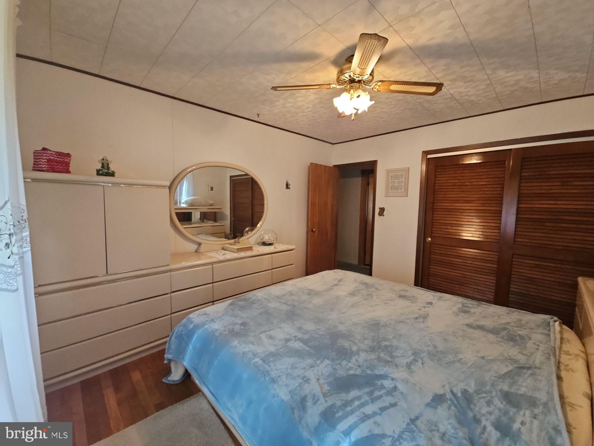 282 Woodruff Road Bridgeton, NJ 08302 - Photo 15 of 19 a bedroom with a bed and a chandelier