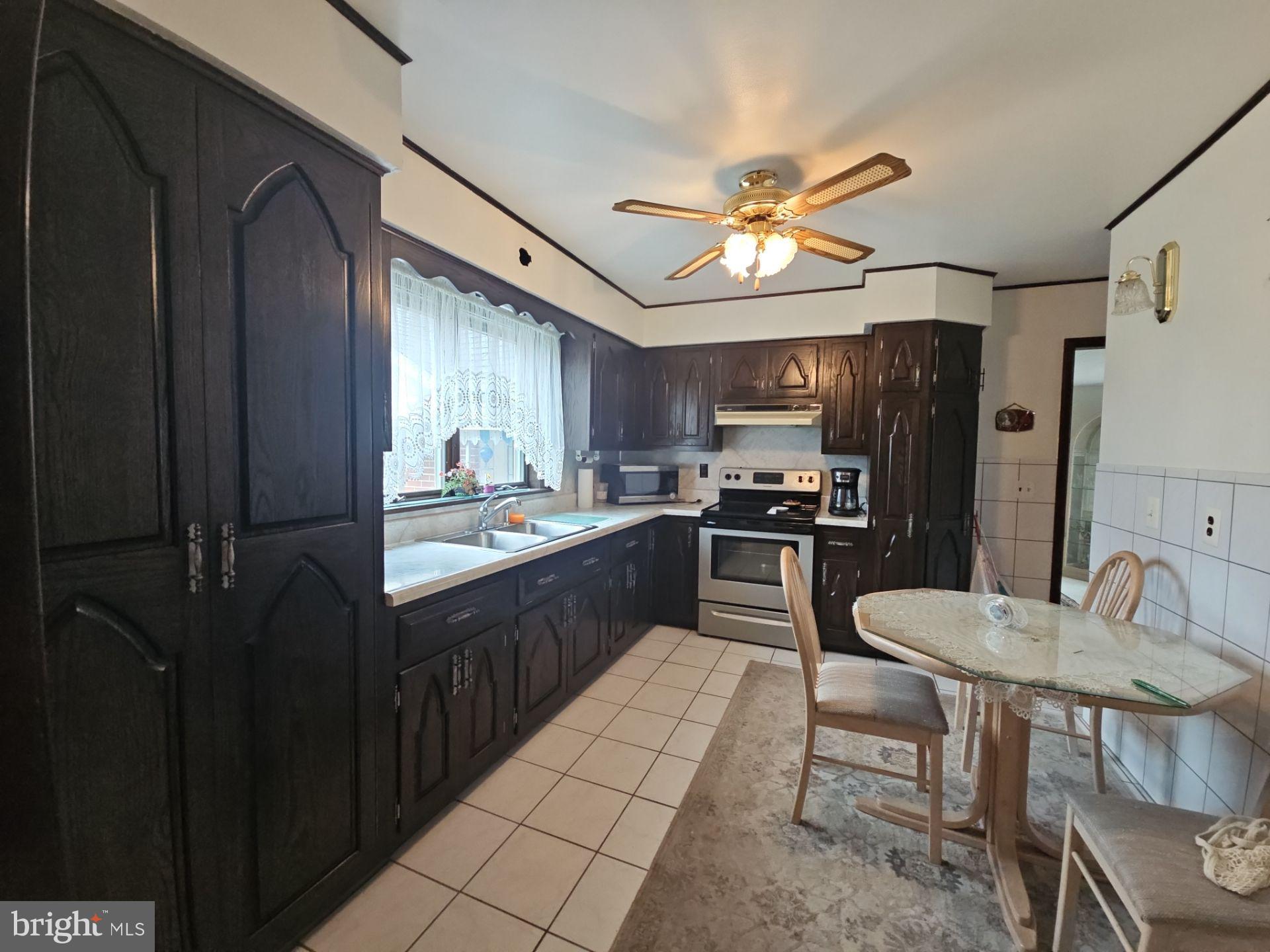 282 Woodruff Road Bridgeton, NJ 08302 - Photo 6 of 19 a kitchen with stainless steel appliances granite countertop a refrigerator a sink a stove and island