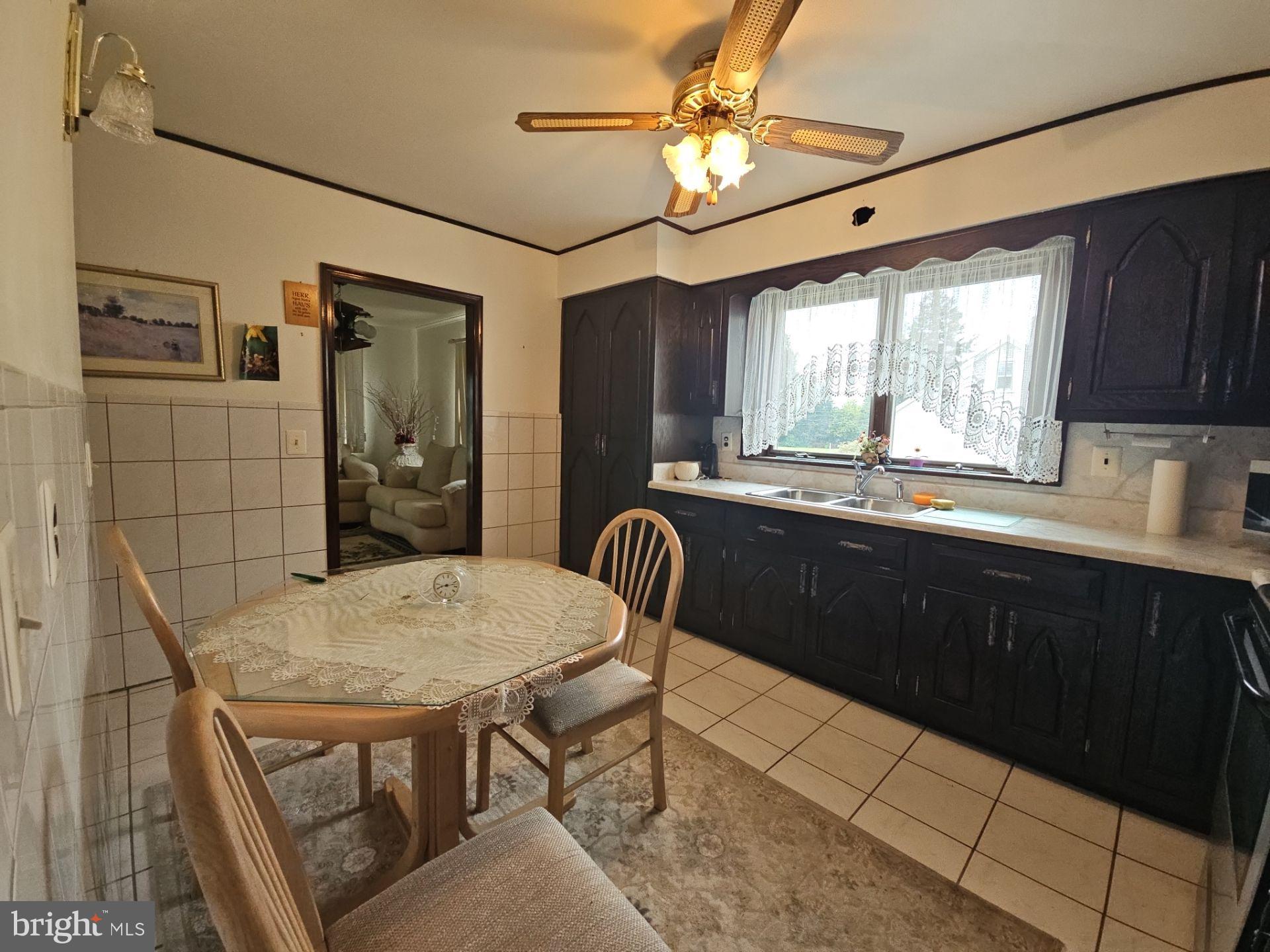 282 Woodruff Road Bridgeton, NJ 08302 - Photo 7 of 19 a kitchen with stainless steel appliances granite countertop a sink a stove a dining table and chairs with wooden floor