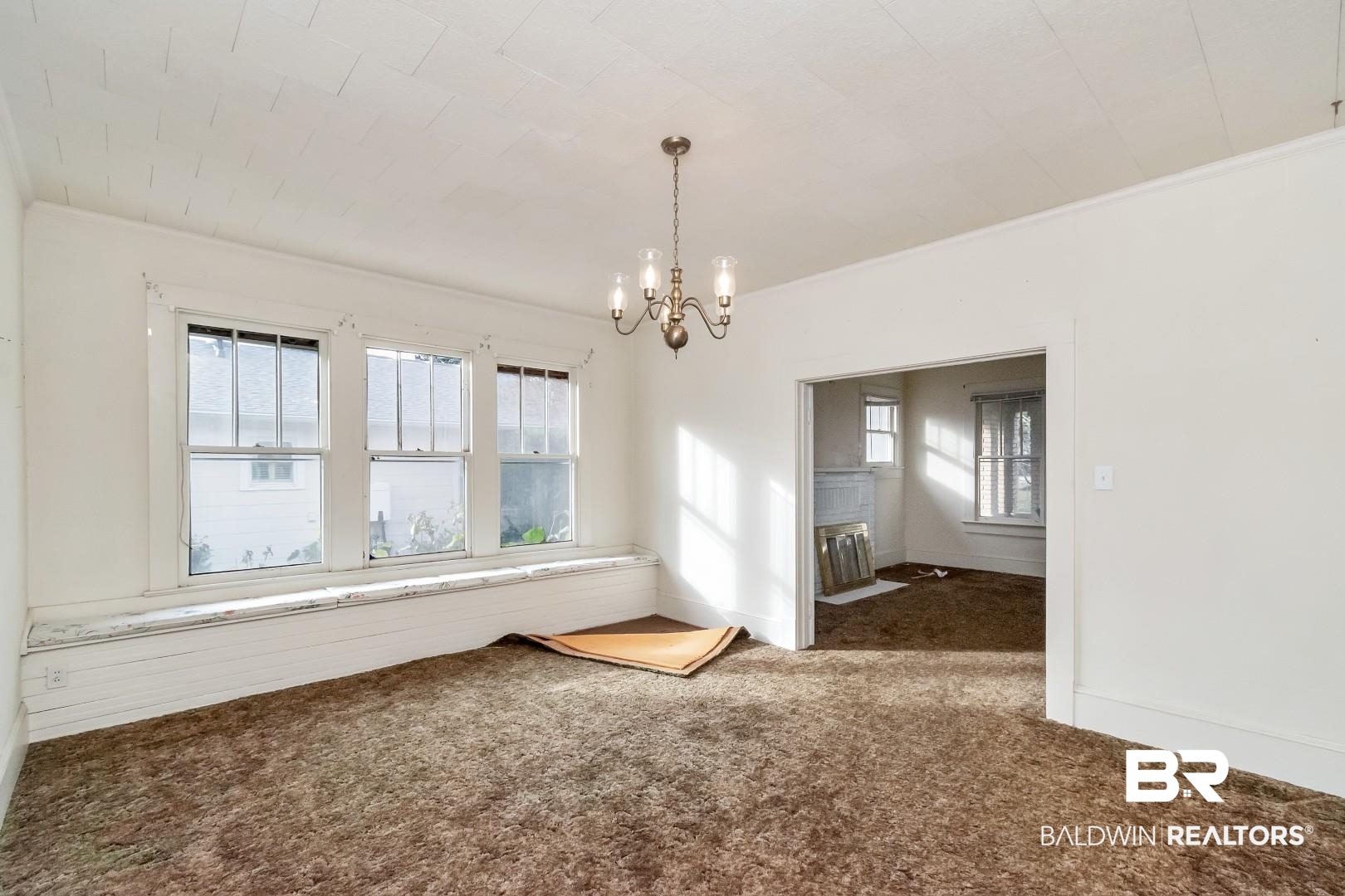 4305 Stein Street Mobile, AL 36608 - Photo 8 of 22 Carpeted spare room with crown molding, plenty of natural light, and a notable chandelier