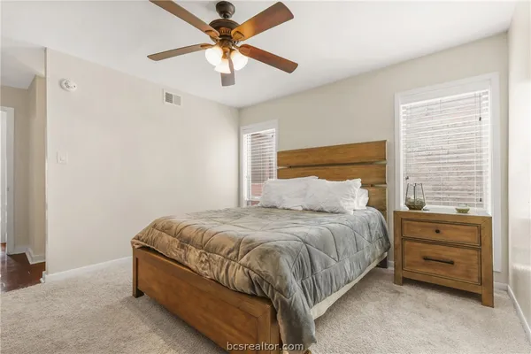 a bedroom with a bed dresser and a window