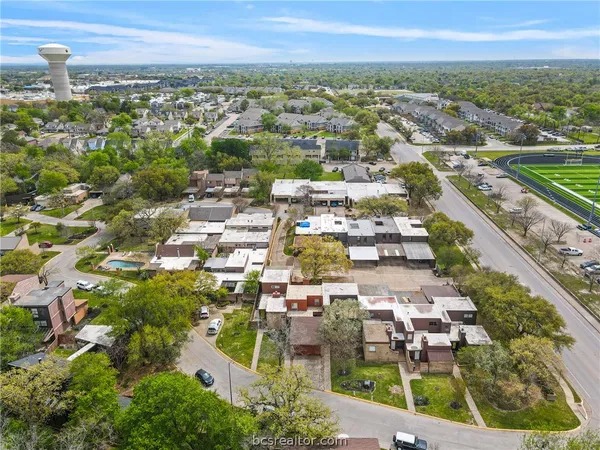 an aerial view of residential houses with city view
