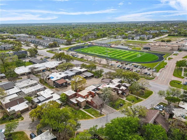 an aerial view of residential houses with outdoor space