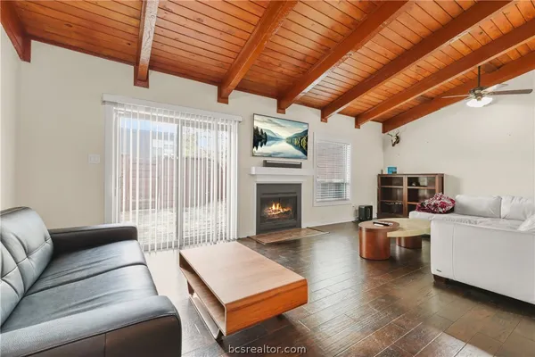 a living room with furniture a fireplace and a table