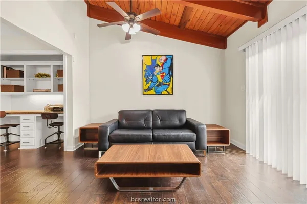 a living room with furniture and wooden floor