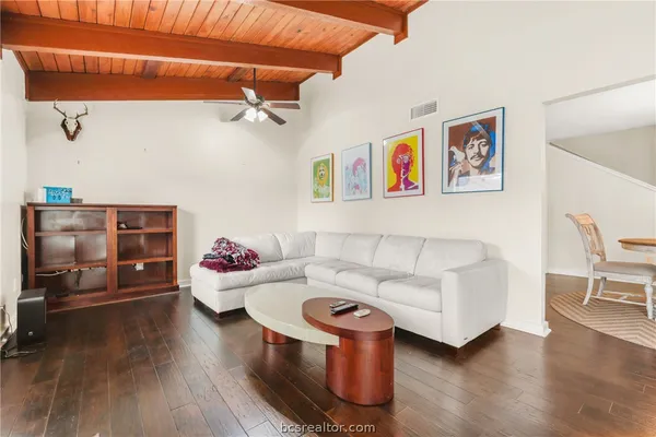 a living room with furniture and wooden floor