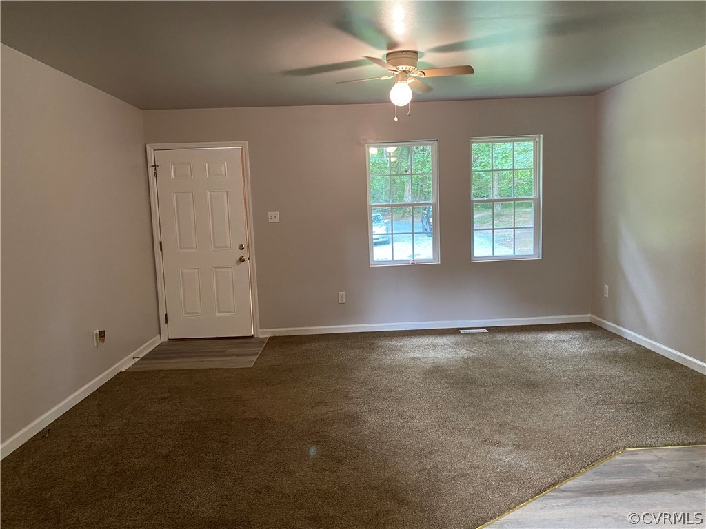 3524 Forest Grove Road Sandy Hook, VA 23153 - Photo 3 of 18 an empty room with chandelier fan and windows