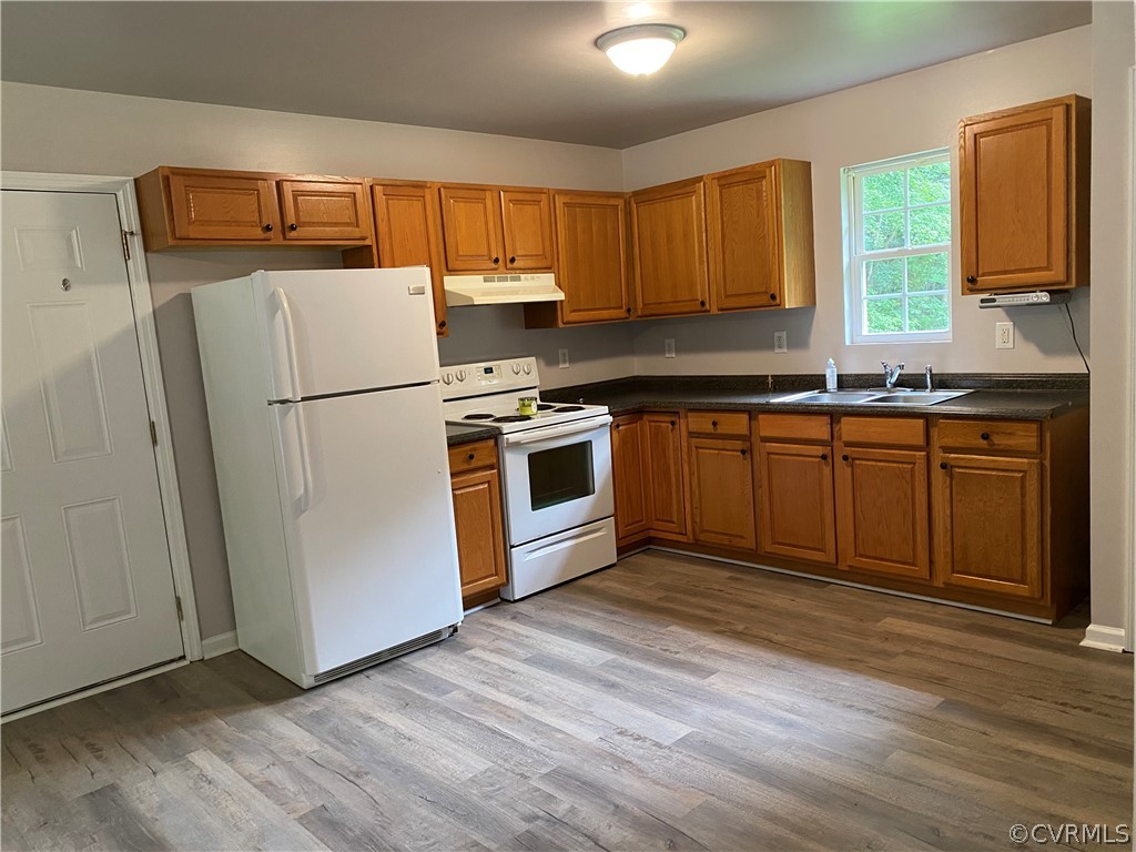 3524 Forest Grove Road Sandy Hook, VA 23153 - Photo 5 of 18 a kitchen with wooden cabinets and white appliances