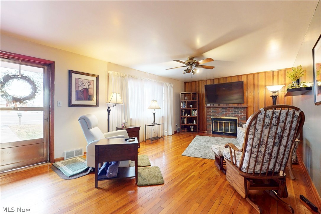 391 Canton Road Steubenville, OH 43953 - Photo 6 of 40 Living area with a ceiling fan, wood-type flooring, and a fireplace