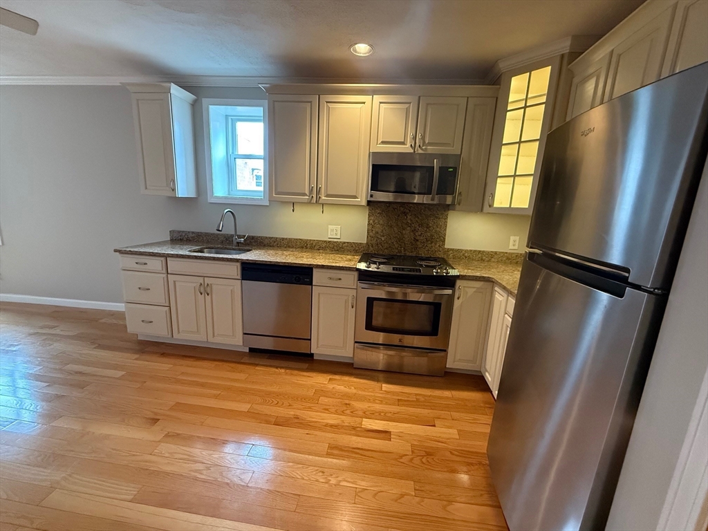 90 Salem Street, Unit 4R Boston, MA 02113 - Photo 1 of 6 a kitchen with stainless steel appliances granite countertop a refrigerator a stove a sink and a microwave
