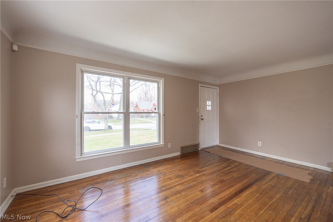 4344 West Anderson Road South Euclid, OH 44121 - Photo 4 of 14 Unfurnished room featuring dark hardwood / wood-style floors and crown molding