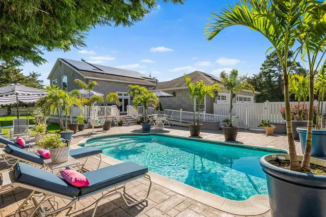 a view of a backyard with plants and patio