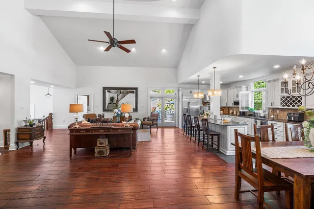 a view of a dining room with furniture chandelier and wooden floor