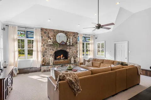 a living room with furniture a window and a fireplace