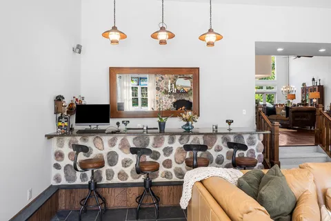 a living room with furniture fireplace and a large window