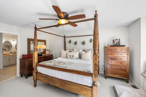 a bedroom with a bed a lamp and a closet