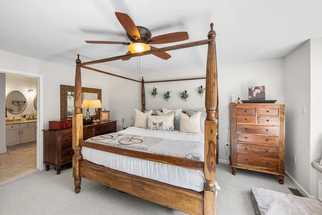 a bedroom with a bed a lamp and a closet