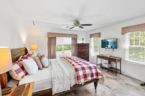 a bedroom with a bed and wooden floor