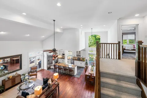 a living room with furniture a fireplace and wooden floor