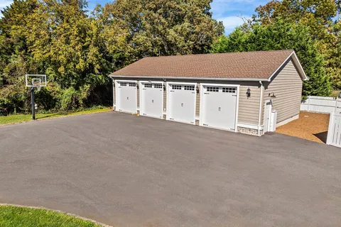 a view of a house with a yard and large tree