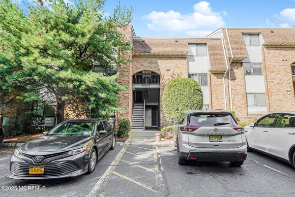 a car parked in front of a brick house