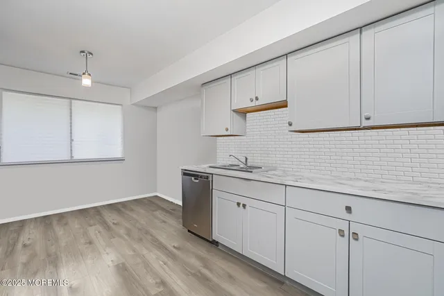 a kitchen with sink cabinets and wooden floor