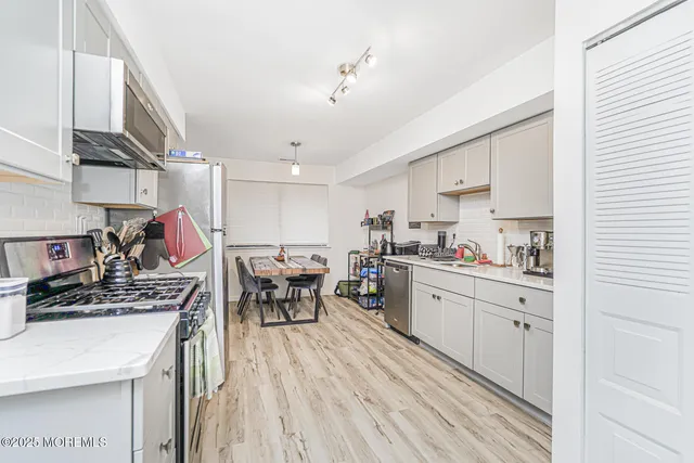 a kitchen with a table chairs stove and cabinets