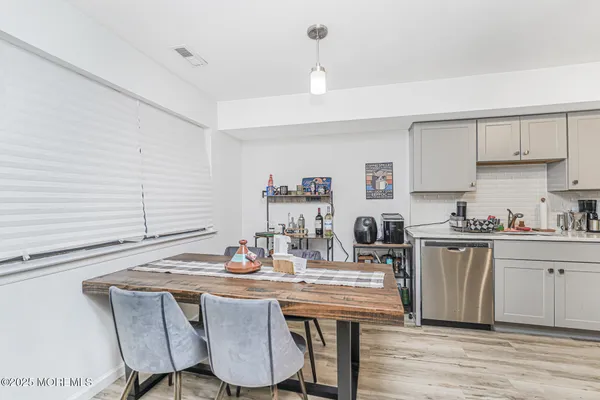a kitchen with a table chairs stove and cabinets