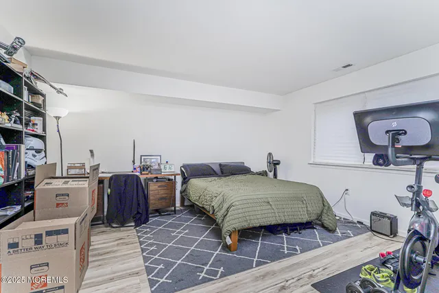 a bedroom with a bed and a book shelf