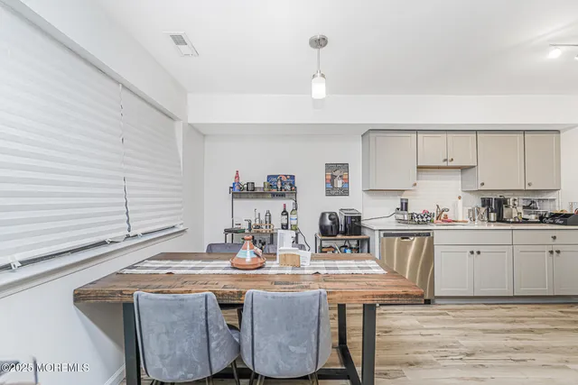 a kitchen with kitchen island stainless steel appliances a sink stove and cabinets
