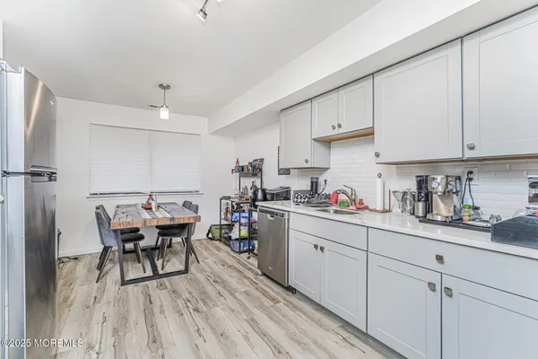 a view of a kitchen with sink and cabinets