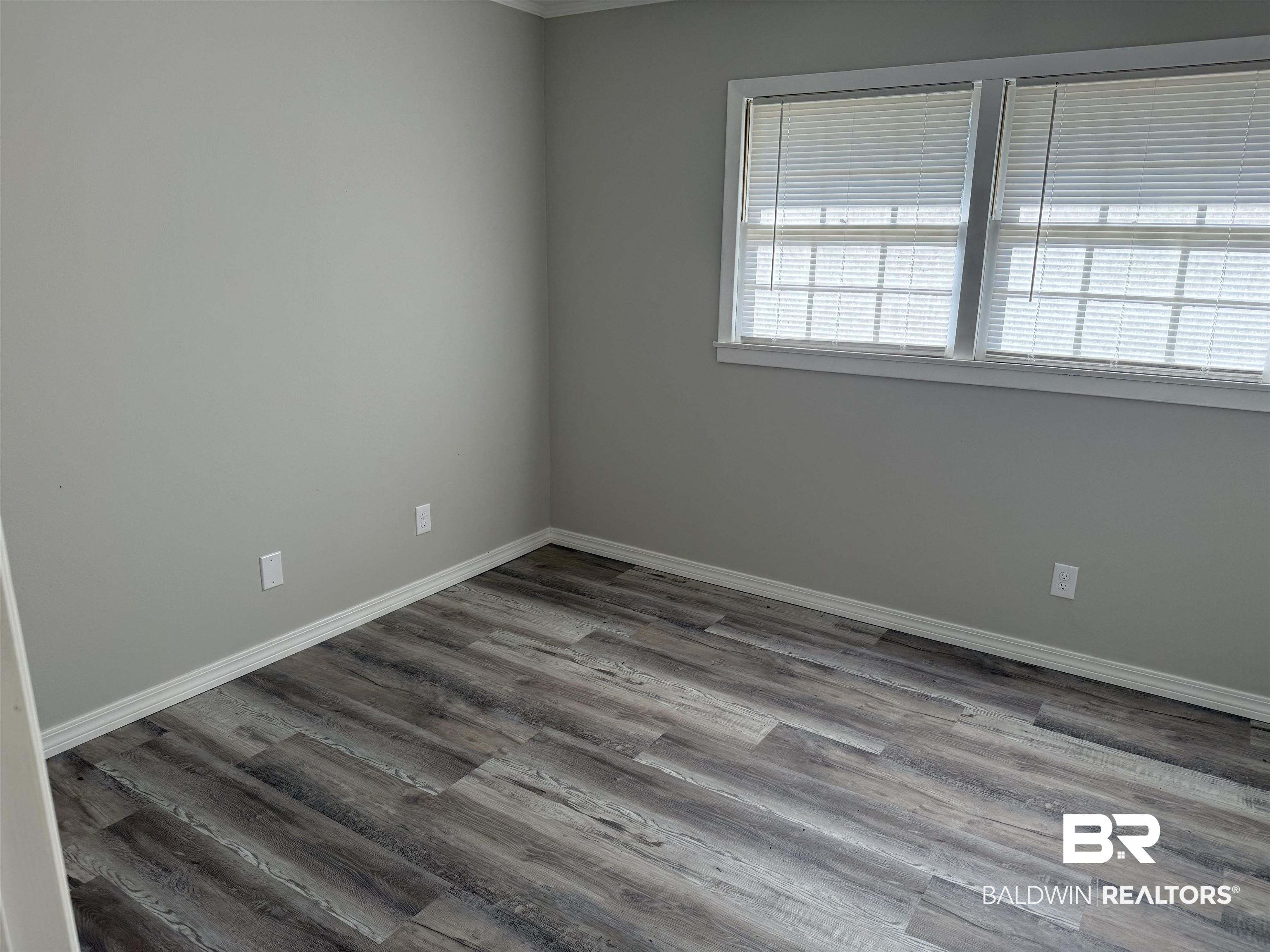 114 Spruce Avenue Brewton, AL 36426 - Photo 7 of 13 Empty room with wood finished floors and baseboards