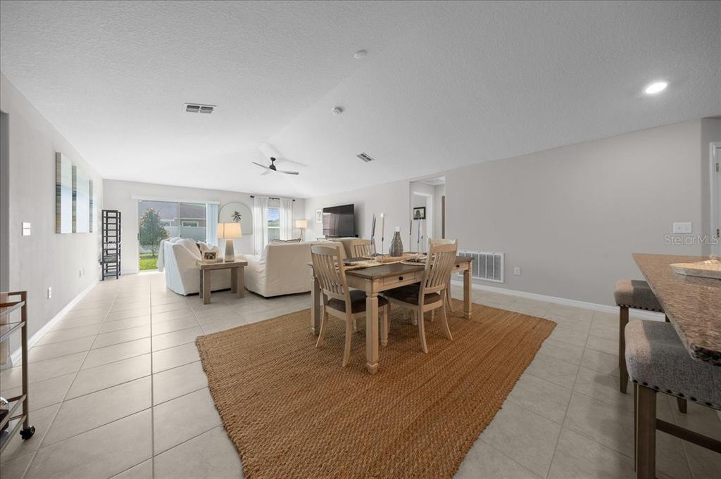 9329 Southwest 57th Terrace Ocala, FL 34476 - Photo 23 of 64 a dining room with furniture and wooden floor