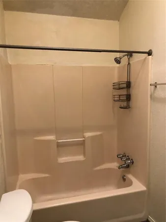 a view of wooden floor and chandelier fan in an empty room