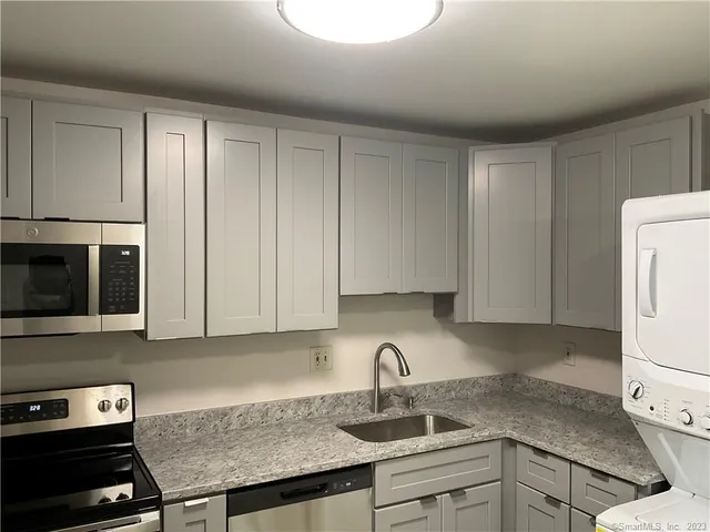 a kitchen with a sink cabinets and appliances