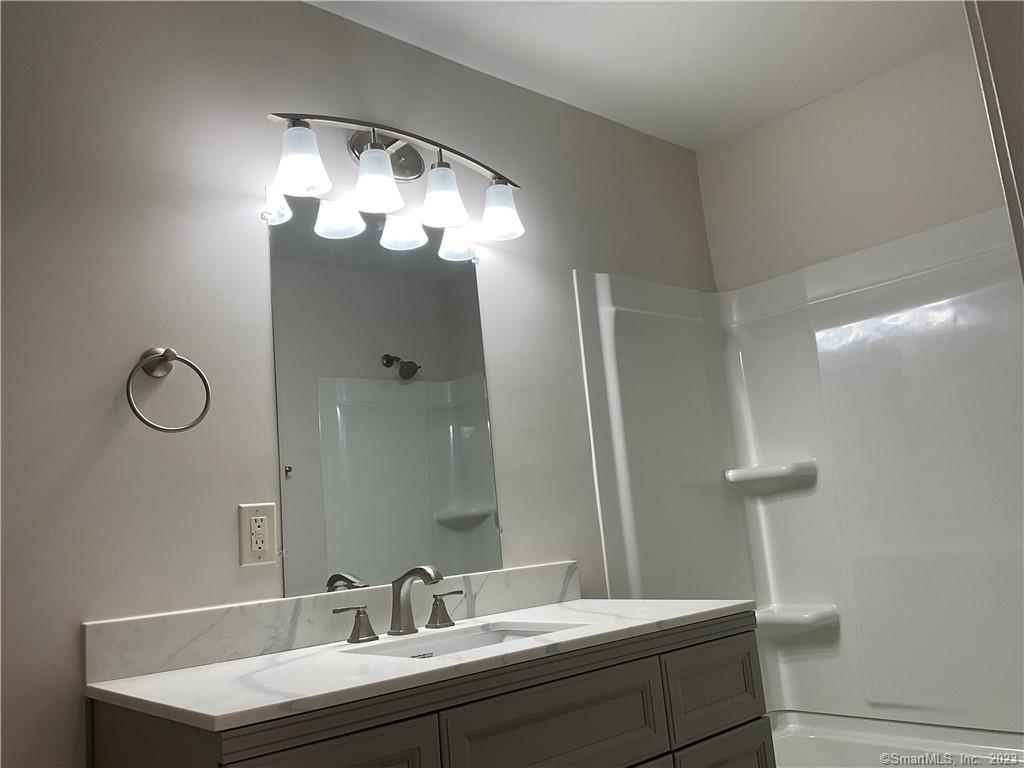 1271 Washington Street, Unit 5 Middletown, CT 06457 - Photo 5 of 19 a bathroom with a sink and a mirror