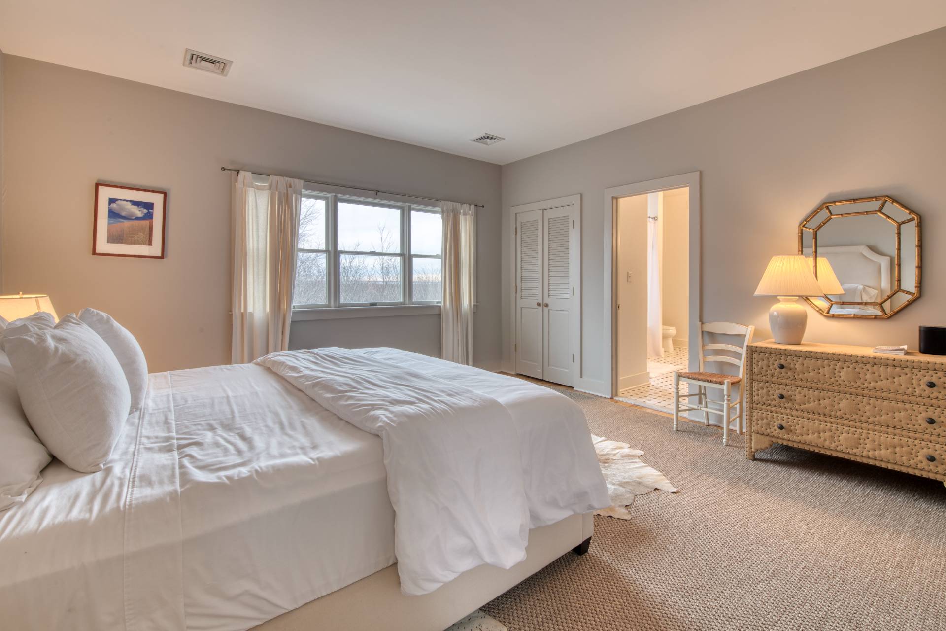 25 Laurel Hill Lane Amagansett, NY 11930 - Photo 8 of 13 a bedroom with a bed and a dresser