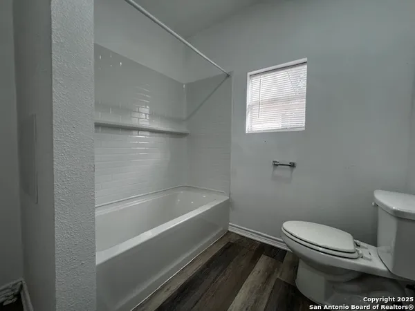 a bathroom with a toilet and bathtub