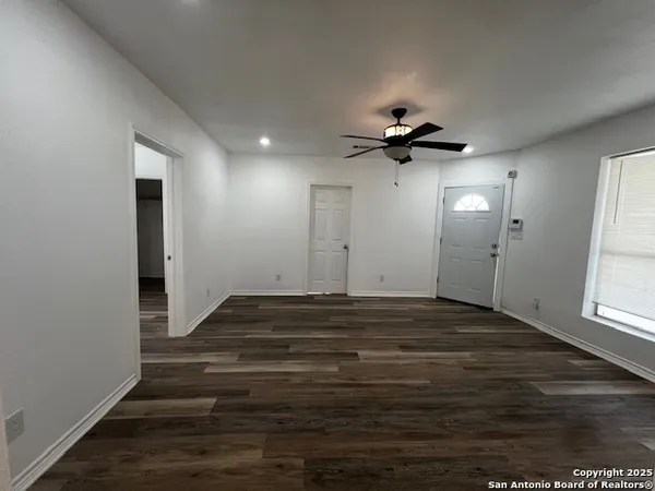 wooden floor in an empty room with a window